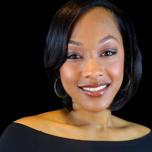 Smiling woman with straight, shoulder-length black hair, wearing hoop earrings and an off-the-shoulder black top, posed against a solid black background.